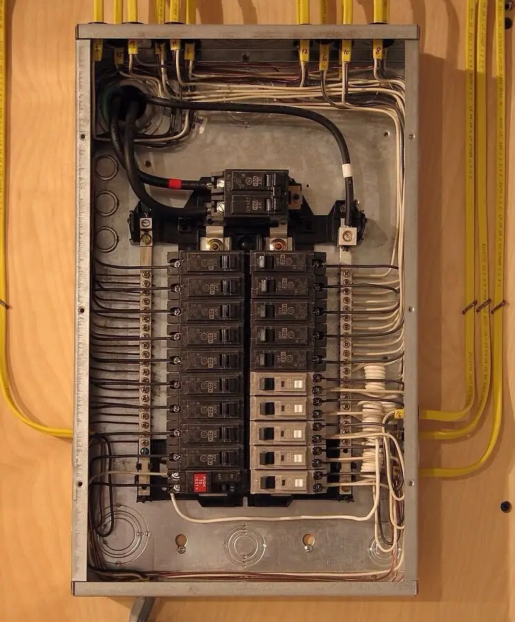 A panel in new framing with yellow cables fanned in from both sides